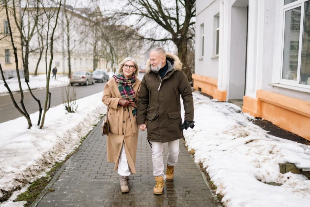 Couple walks in the cold winter months living an arthritis free living